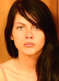 Beautiful brunette gets rid of her top exposing her large boobs